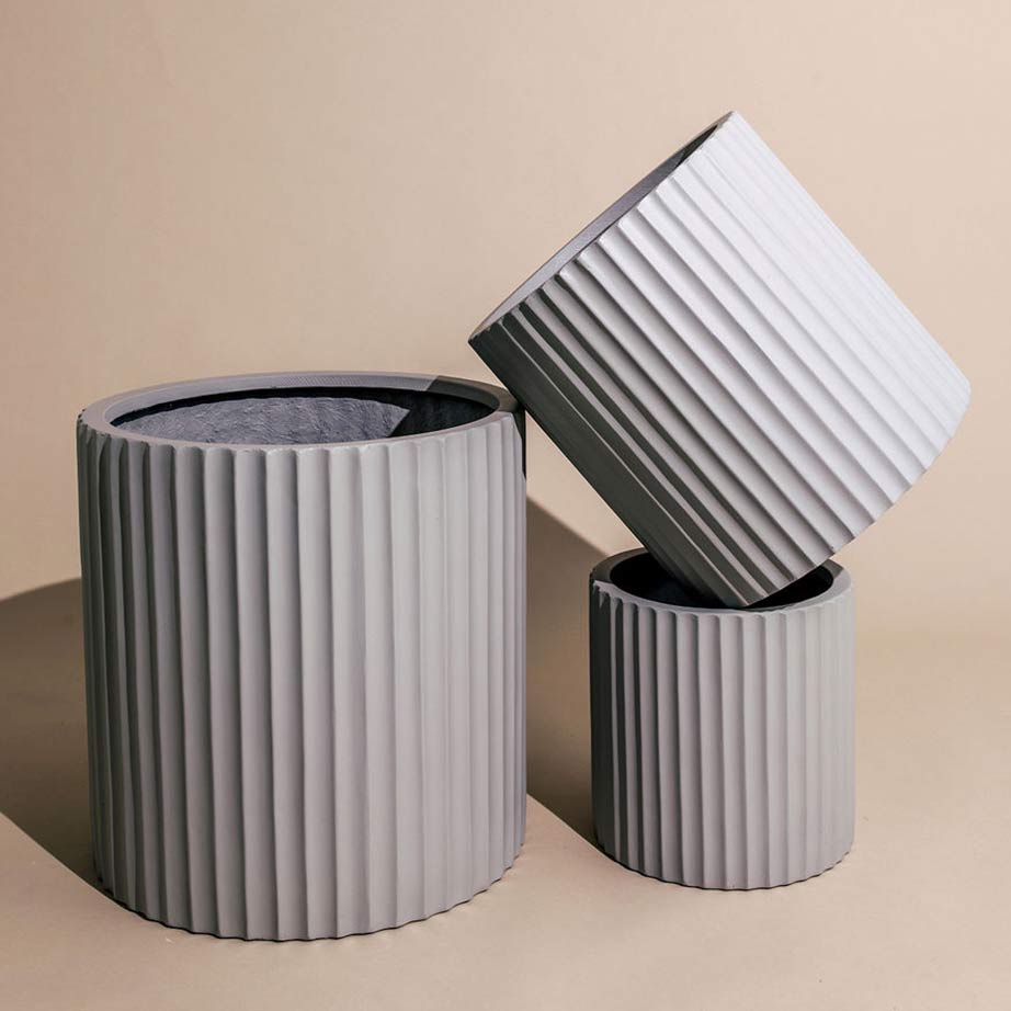 Artfully posed grey coloured textured garden pots.